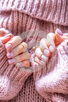 Art nail manicure for bride in purple sweater. Gel nails in soft pink color