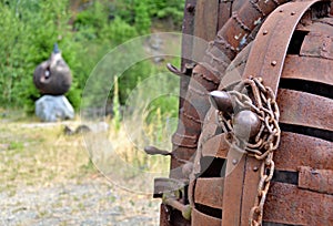 Art in nature - detail of rusty metal closed cell with chain wit