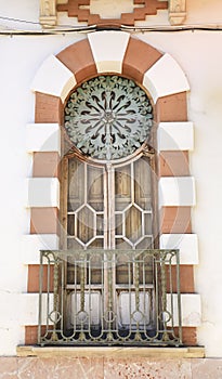 Art nouveau style window with forged metal details