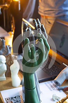 Art Object human hands printed 3D printer. Model prototype of human hand printed