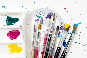 Art Paint brushes, palette and colorful splatter