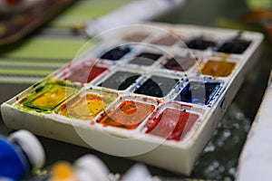 Art Palette with Colorful Paints Close Up View. Open Aquarelle Watercolor Palette at Art Studio Open Space. Artist Work