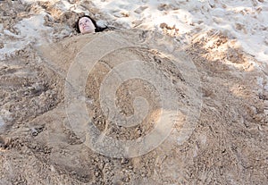 Art photo of beautiful lady buried in the sand