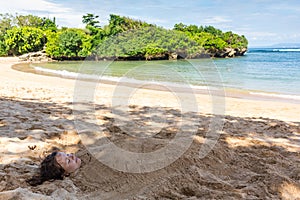 Art photo of beautiful lady buried in the sand