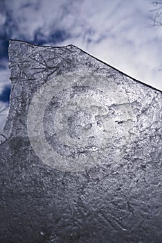 Art photo - ice and sky. A piece of ice. A fragment of an ice floe against the sky.