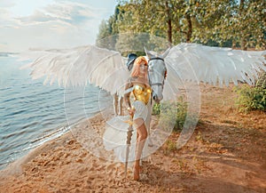 Art photo real people Fantasy woman warrior queen hand strocking white horse with wings pegasus animal. goddess girl