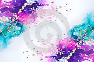 art photography of abstract fluid art painting with alcohol ink blue, purple, pink, gold colors and crystal rhinestones photo