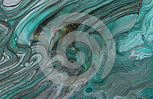 art photography of abstract marbleized effect background with turquoise, green and blue creative colors. Beautiful paint