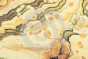 art photography of abstract marbleized effect background with yellow, gold and white creative colors. Beautiful paint