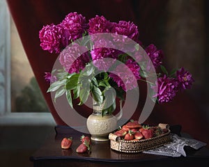 Still life with bouquet of peonies and strawberries