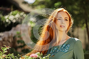 Art portrait of beautiful girl with long red hair