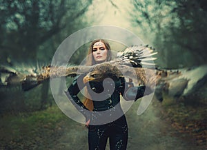 art portrait real people fantasy woman assassin holding white-tailed eagle bird flaping open wings flies on hand. Elf