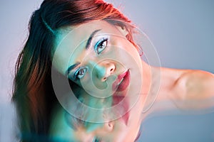 Art, reflection and beauty, portrait of woman on studio background with neon light and makeup. Fashion, skin and