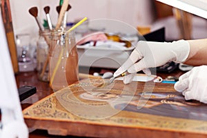 Art restorer working on the ancient icon