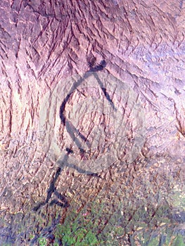 Art in sandstone cave. Black carbon paint of human hunting