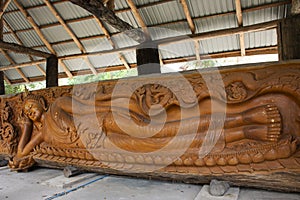 Art sculpture carving wooden ancient buddha reclining statue for thai people traveler travel visit and respect praying blessing of