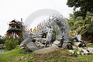 Art sculpture carving wooden chinese ancient dragon and wood antique snake naga gardening in garden park for thai people travel