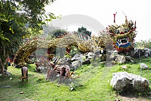 Art sculpture carving wooden chinese ancient dragon and wood antique snake naga gardening in garden park for thai people travel