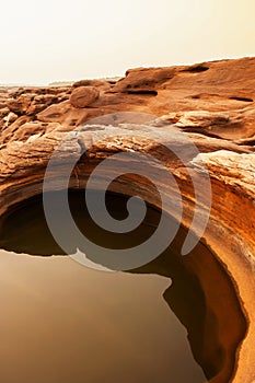 Art shape of sandstone pool in the Mekong River in summer