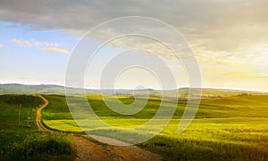 Art spring farmland and country road; tuscany countryside rolling hills