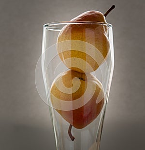 Art still life with small red pears in glass on