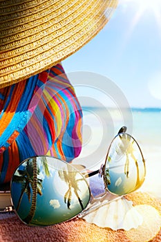 Art Straw hat and sun glasses on a tropical beach