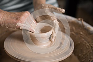 Women`s hands and potter`s wheel