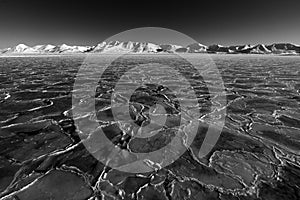 Art view on winter Arctic. White snowy mountain, blue glacier Svalbard, Norway. Ice in ocean. Iceberg in North pole. Global warmin photo