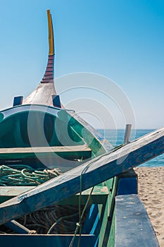 Arte Xavega typical portuguese old fishing boat on the beach in