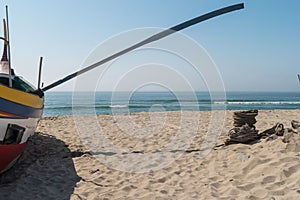 Arte Xavega typical portuguese old fishing boat on the beach in photo