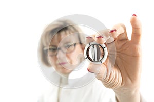 Arteficial heart valve in a hand of a female doctor photo