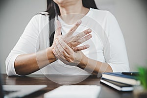 Arthritis person, finger woman ache from working in office. Concept office syndrome hand pain from occupational disease, woman
