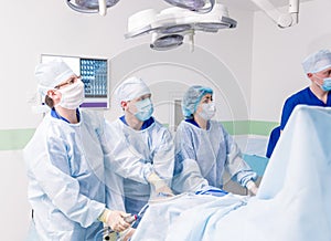 Arthroscope surgery. Orthopedic surgeons in teamwork in the operating room photo
