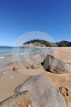 Arthur Bay beach scene with granite boulders in foreground, Magnetic Island, QLD, Australia