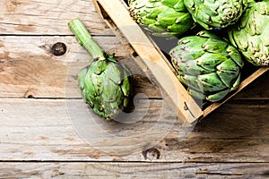 Artichoke. Box of fresh artichoke. Harvest concept. Copy space photo