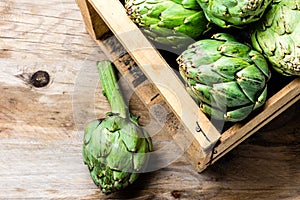 Artichoke. Box of fresh artichoke. Harvest concept. Copy space photo