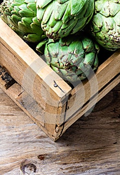 Artichoke. Box of fresh artichoke. Harvest concept. Copy space photo