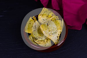 Artichoke Hearts in brown bowl red napkin, landscape, copyspace