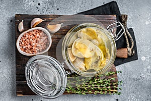 Artichoke hearts marinated in olive oil. Gray background. Top view