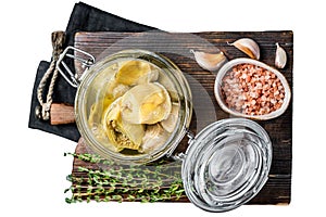 Artichoke hearts marinated in olive oil. Isolated, white background.