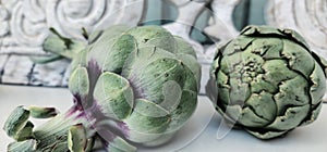 Artichokes and background from vintage rustic decorative element. Wood carving.