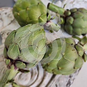 Artichokes and background from vintage rustic decorative element. Wood carving.