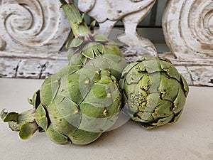 Artichokes and background from vintage rustic decorative element. Wood carving.