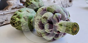 Artichokes and background from vintage rustic decorative element. Wood carving.