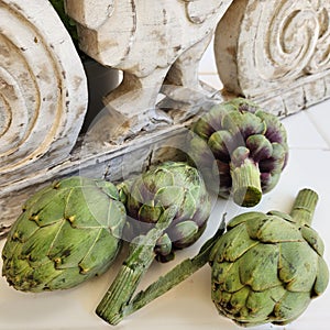 Artichokes and background from vintage rustic decorative element. Wood carving.