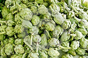 Artichokes vegetables in a market mound photo