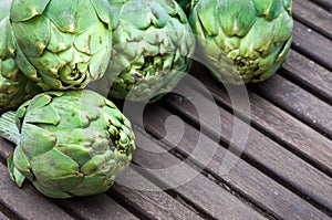 Artichokes on wooden table