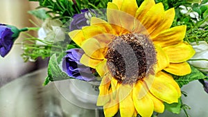 Articial flower in white vase on the table