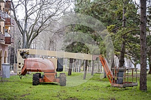 Articulated Boom Lift in the grass in a park.