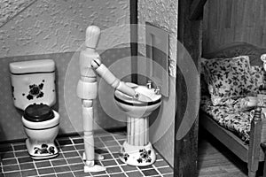 Articulated mannequin in the bathroom of a rural house photo